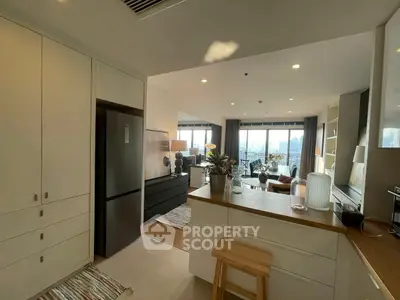 Modern open-layout kitchen and living room with city view