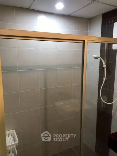 Modern bathroom with glass shower enclosure and sleek tile design