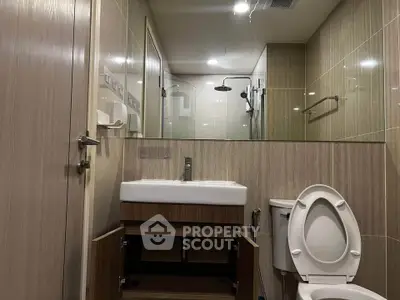 Modern bathroom with sleek fixtures and glass shower enclosure