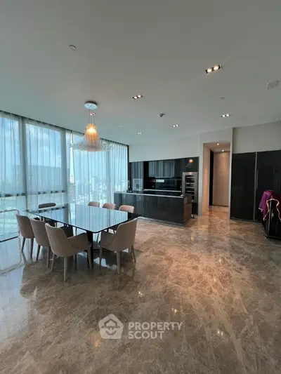 Luxurious open-plan kitchen and dining area with marble flooring and panoramic city views.