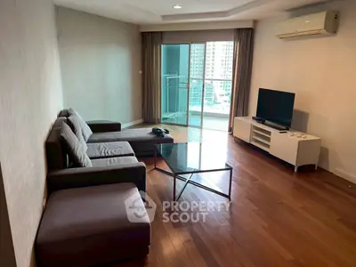 Spacious living room with modern furniture and balcony view in urban apartment