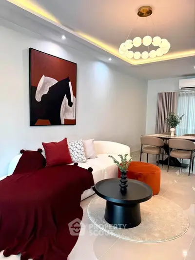 Stylish living room with modern decor, elegant lighting, and cozy seating area.
