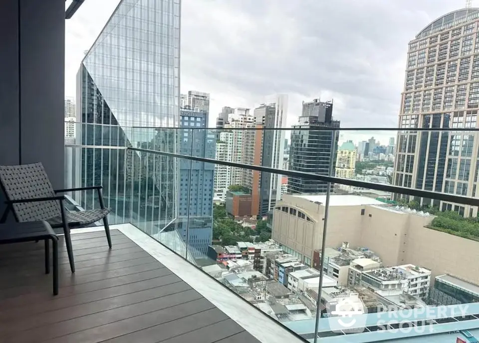 Stunning city view from modern high-rise balcony with glass railing