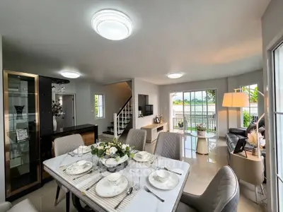 Luxurious open-plan living and dining area with elegant decor and natural light.