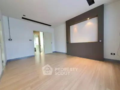 Spacious modern living room with sleek wooden flooring and recessed lighting