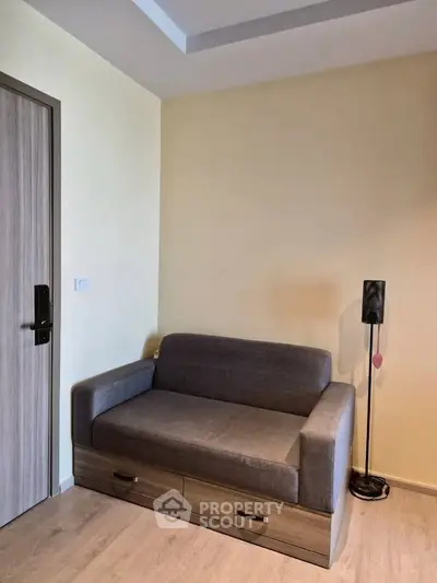 Cozy living room corner with modern gray sofa and sleek floor lamp.