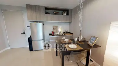 Modern kitchen with dining area featuring sleek cabinetry and stainless steel appliances.