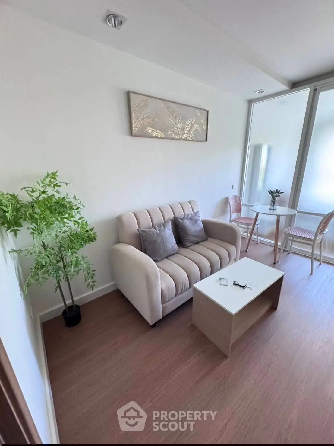 Charming living room with cozy sofa and dining area, perfect for relaxation and entertaining.