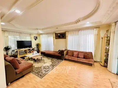Spacious living room with elegant ceiling design and ample natural light
