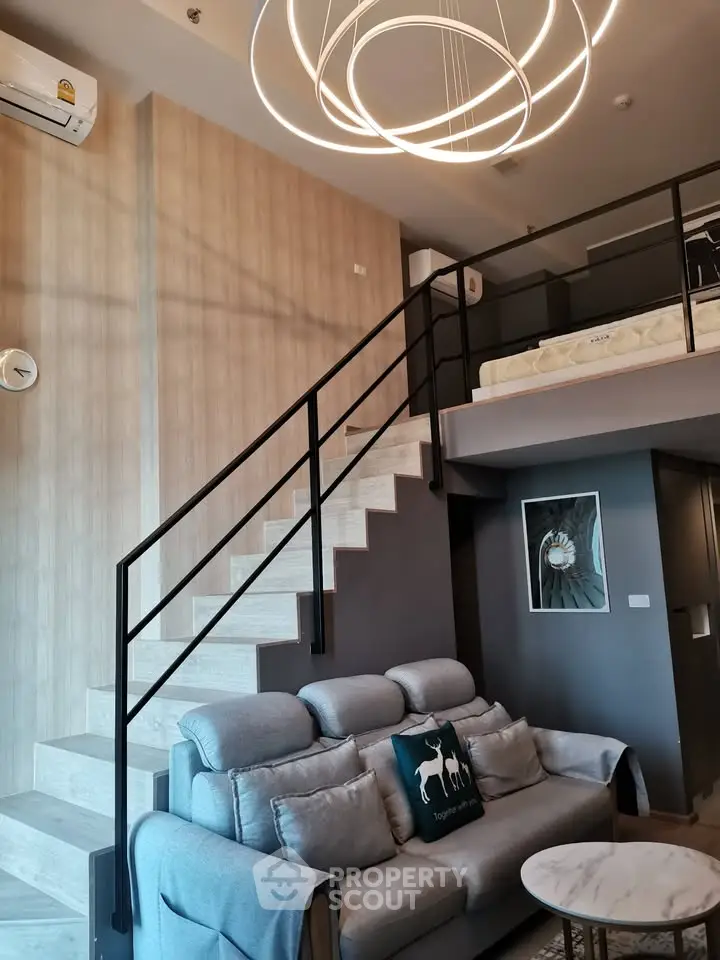 Modern loft apartment with stylish staircase and cozy living area
