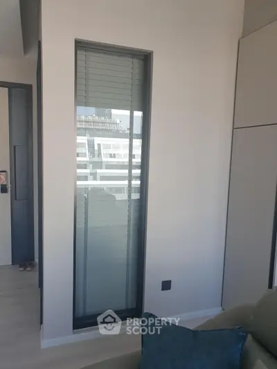 Modern apartment interior with tall window and sleek design