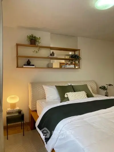 Cozy bedroom with stylish decor and elegant lighting