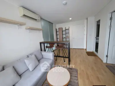 Modern living room with stylish furniture and wooden flooring in a cozy apartment.
