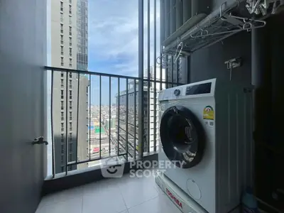 Modern high-rise balcony with washing machine and city view