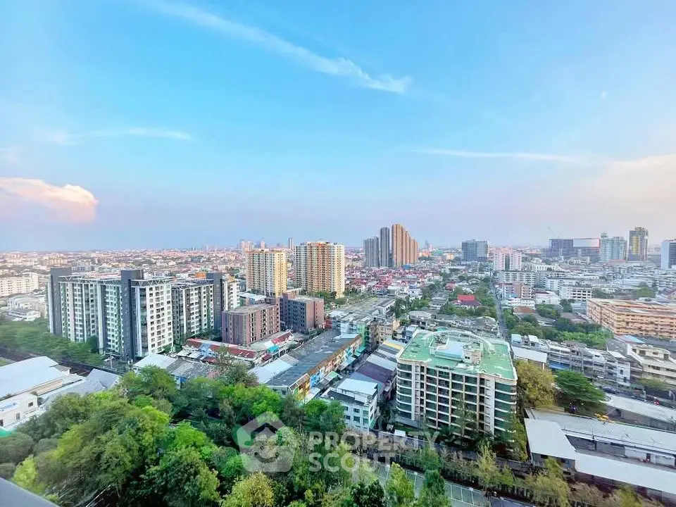 Stunning cityscape view from high-rise apartment showcasing urban skyline and lush greenery.