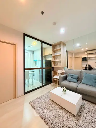 Modern living room with glass partition and cozy decor in a stylish apartment.
