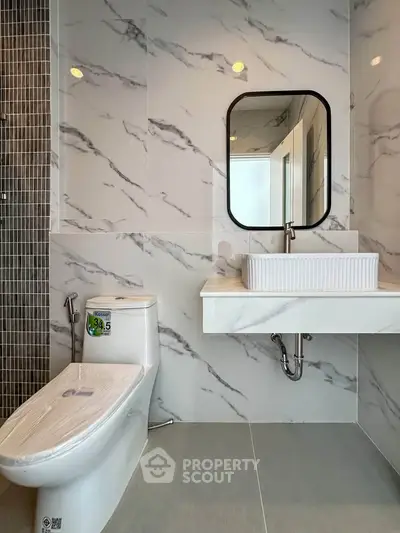 Modern bathroom with sleek marble tiles and contemporary fixtures