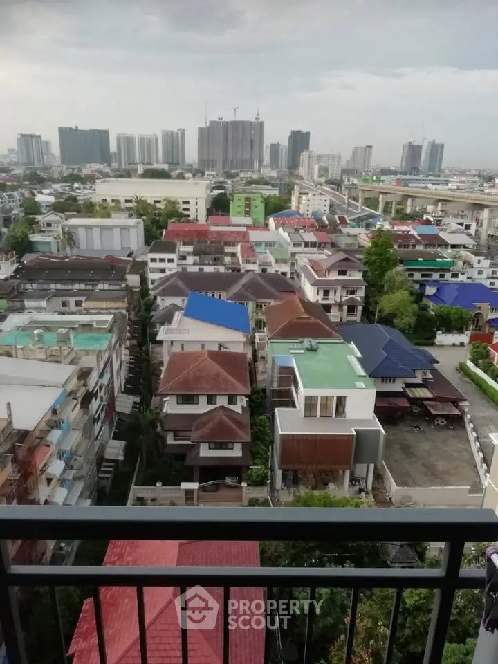 Stunning cityscape view from a high-rise balcony overlooking urban residential area.