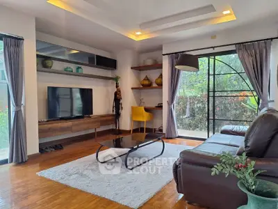 Stylish living room with modern decor, large windows, and cozy seating area.