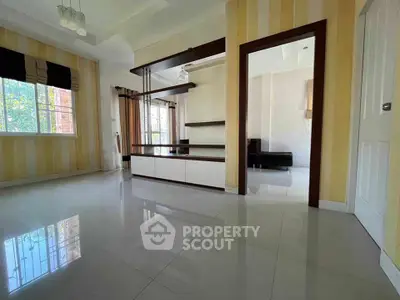 Spacious living room with modern shelving and large windows for natural light.