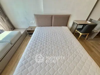 Modern bedroom with stylish furniture and natural light, featuring a comfortable bed and elegant decor.