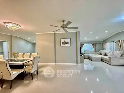 Spacious modern living room with elegant dining area and luxurious seating, perfect for entertaining.