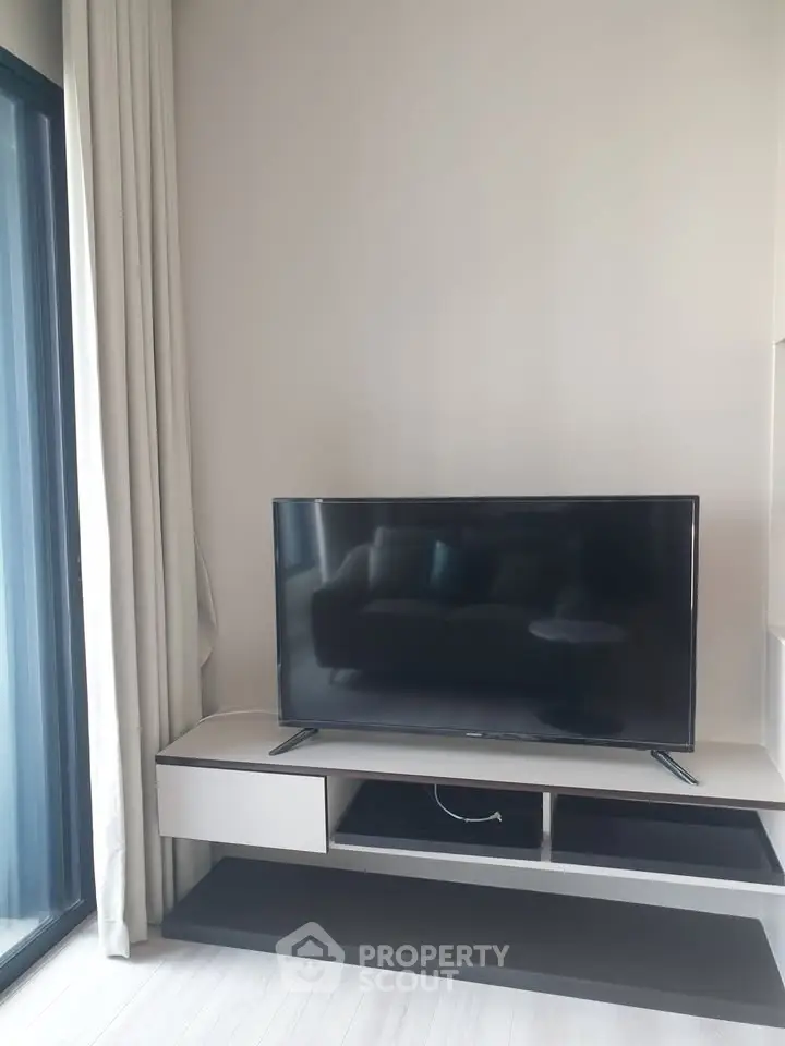 Modern living room with sleek TV setup and natural light