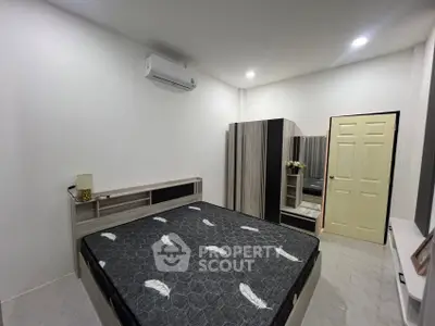 Modern bedroom with stylish furniture and air conditioning, perfect for comfort and relaxation.