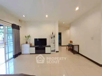 Spacious living room with modern decor and large windows for natural light.