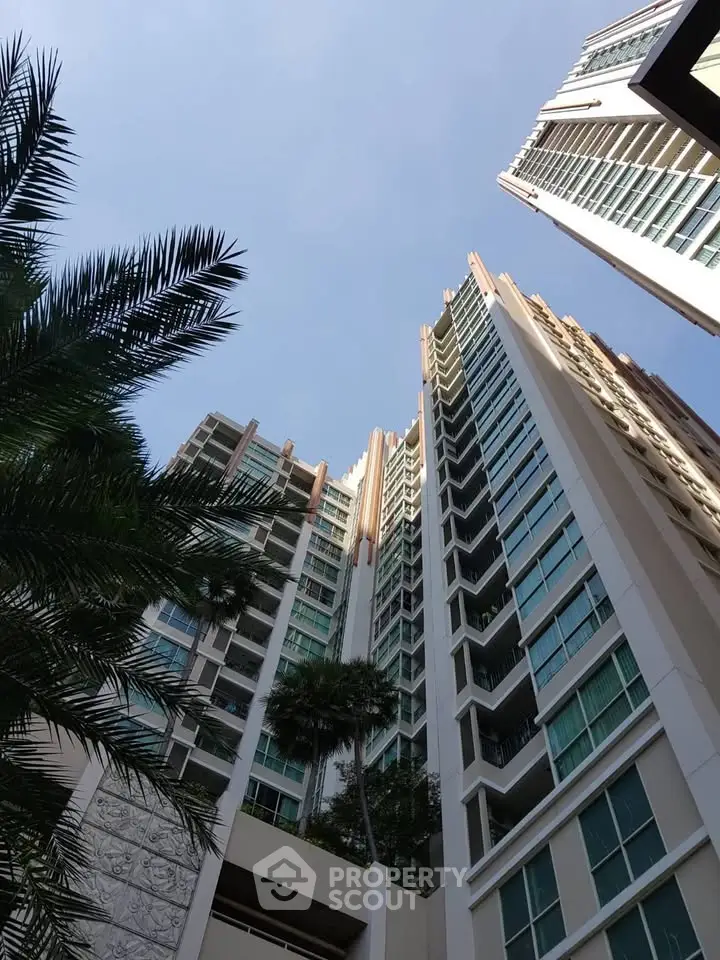 Stunning high-rise building with modern architecture and lush greenery, perfect for urban living.