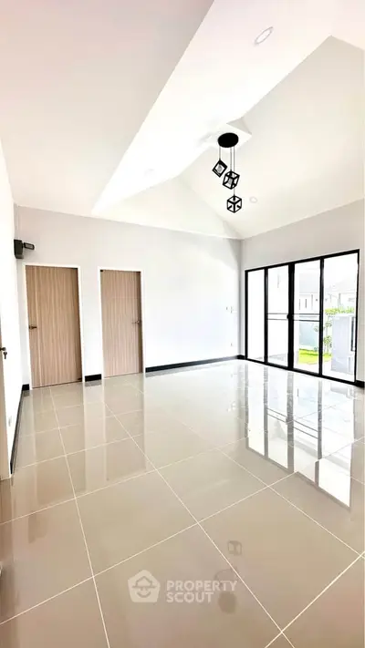 Spacious modern living room with high ceilings and large windows for natural light.