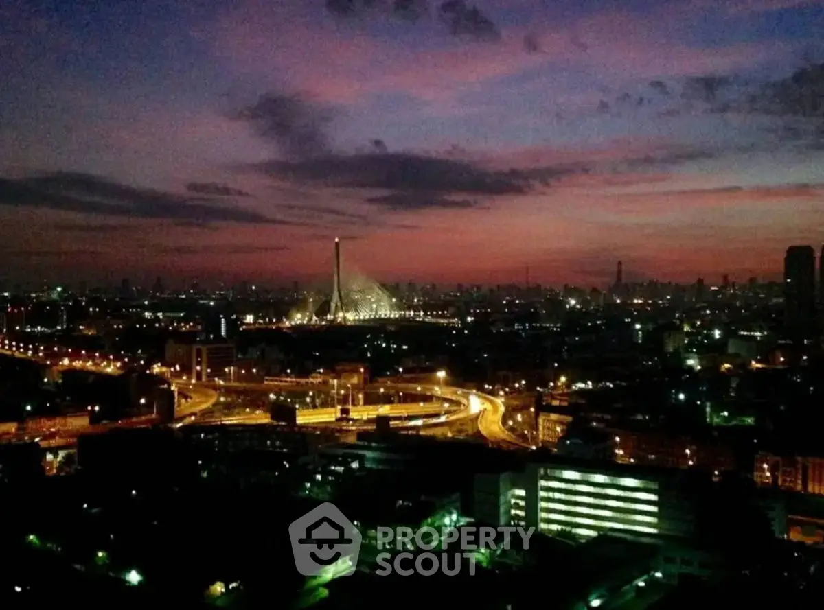 Stunning cityscape view with illuminated skyline and iconic bridge at dusk.