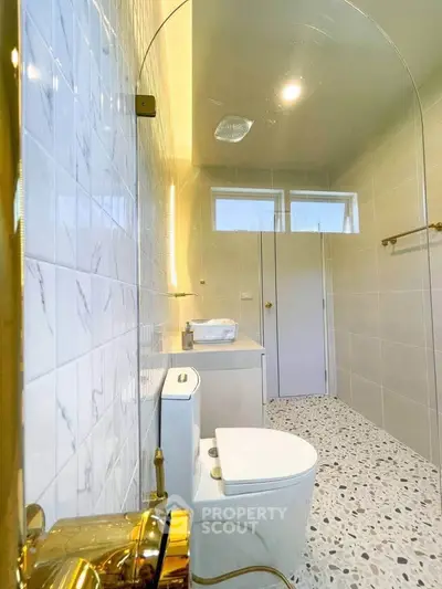 Modern bathroom with terrazzo flooring and elegant fixtures