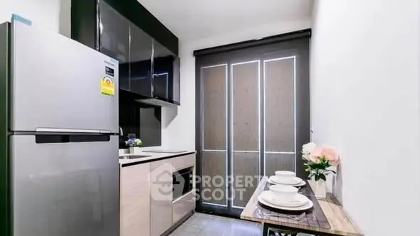 Modern compact kitchen with sleek appliances and stylish decor