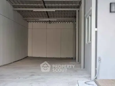 Spacious covered parking area with modern design and ample lighting.