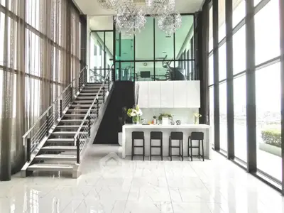 Luxurious modern living room with high ceilings and elegant staircase