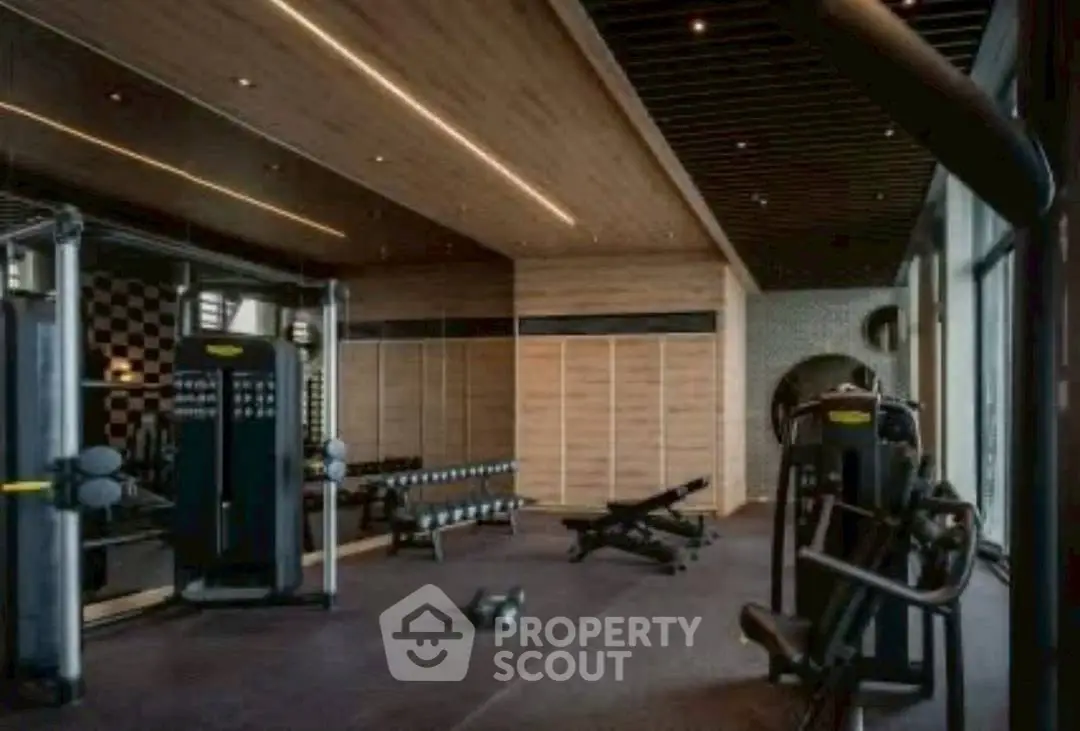 Luxurious modern gym with state-of-the-art equipment and stylish wooden accents.