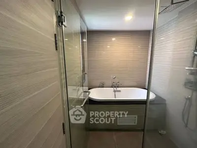 Modern bathroom with glass shower and built-in bathtub