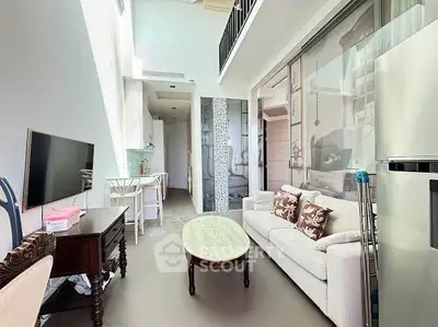 Modern loft-style living room with high ceilings and elegant decor