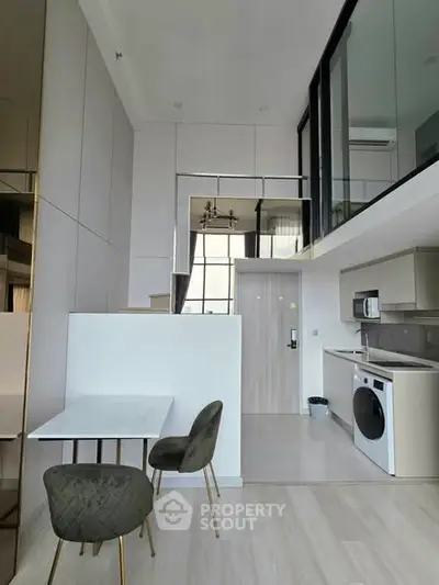 Modern duplex apartment with sleek kitchen and stylish dining area