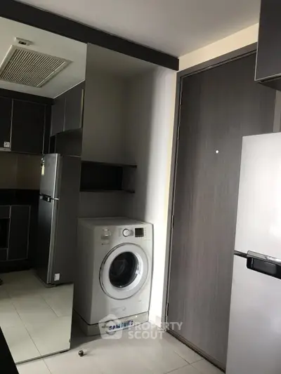 Modern kitchen with washing machine and sleek appliances