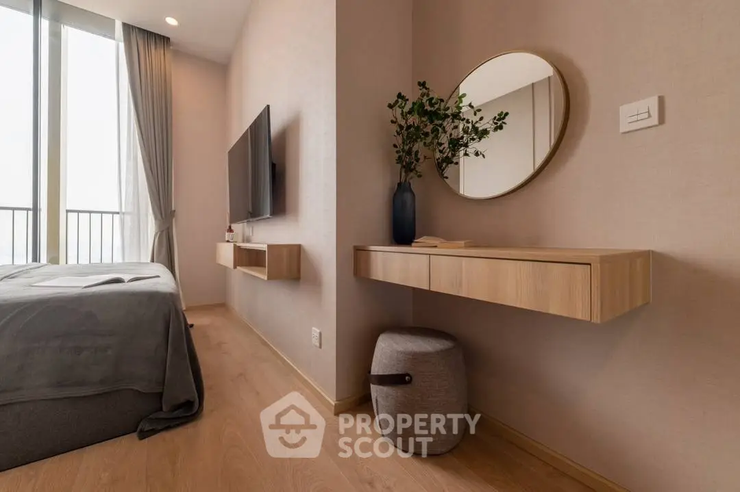 Modern bedroom with sleek design, featuring a wall-mounted TV and elegant decor.