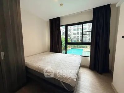 Cozy bedroom with pool view in modern apartment