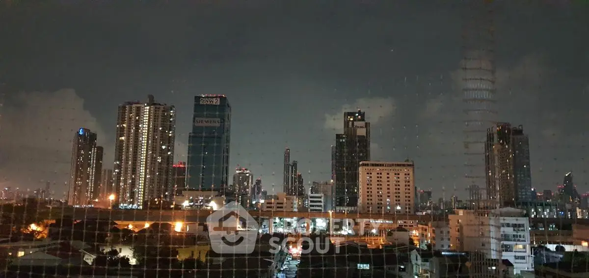 Stunning night skyline view of modern cityscape with illuminated skyscrapers.
