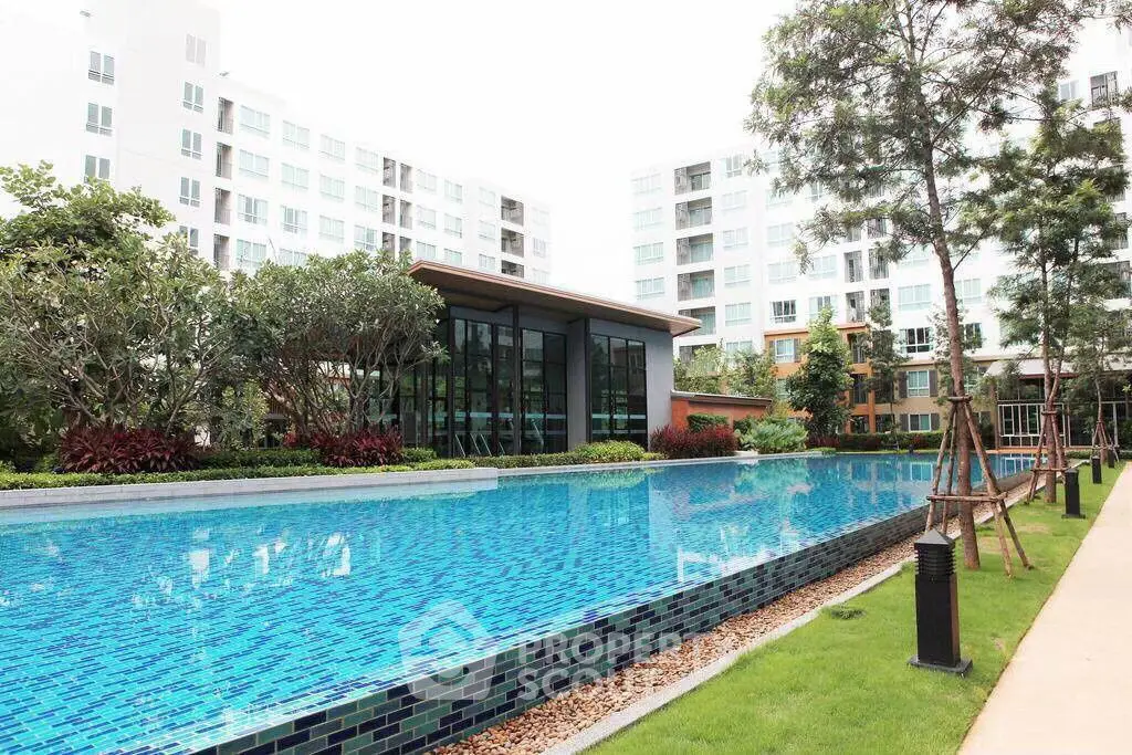 Luxurious apartment complex with stunning outdoor pool and lush landscaping