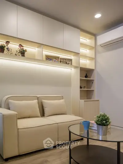 Modern living room with cozy beige sofa, built-in shelves, and ambient lighting.