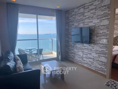 Stunning ocean view living room with modern decor and balcony access