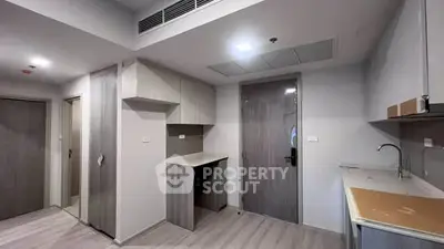 Modern kitchen with sleek cabinetry and minimalist design in a contemporary apartment.