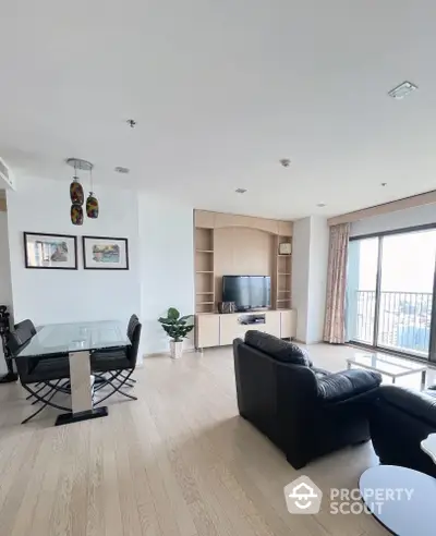 Spacious living room with modern decor and balcony view in luxury apartment