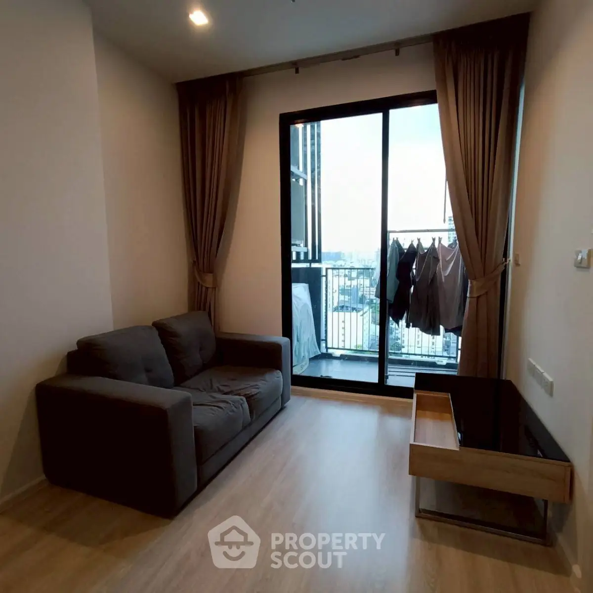 Modern living room with balcony view in high-rise apartment